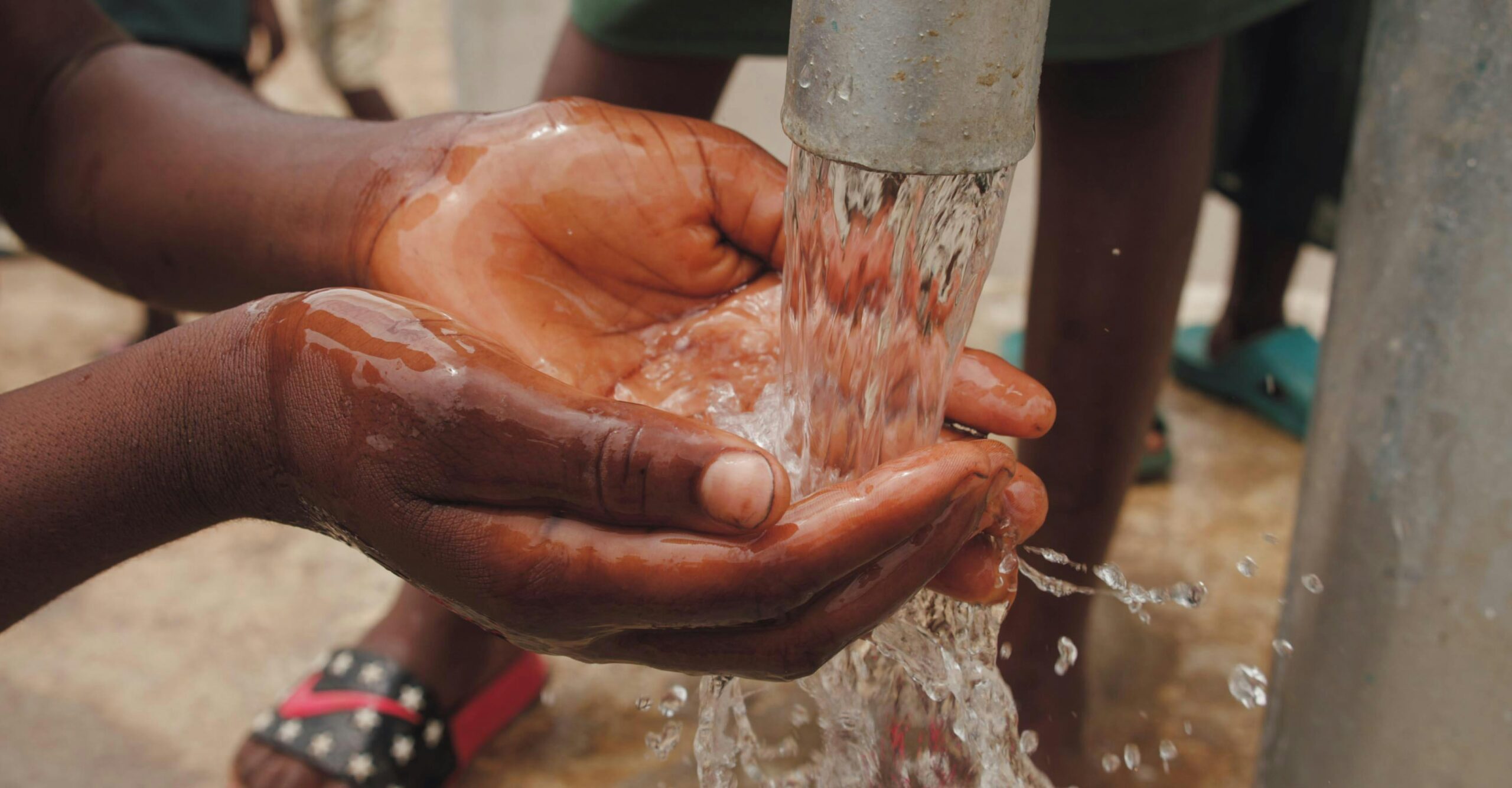 pexels-photo-3030281-3030281 Hands capturing fresh water from a pump, highlighting cleanliness and resources.